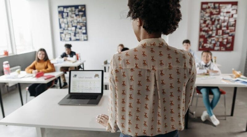Students engaging with AI-powered learning tools in a modern classroom
