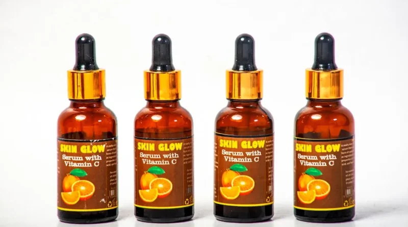 Seven vitamin C serums lined up on bathroom counter for 30-day testing