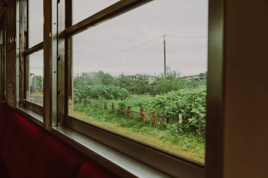 Traveler journaling on a train through scenic countryside slow travel experience
