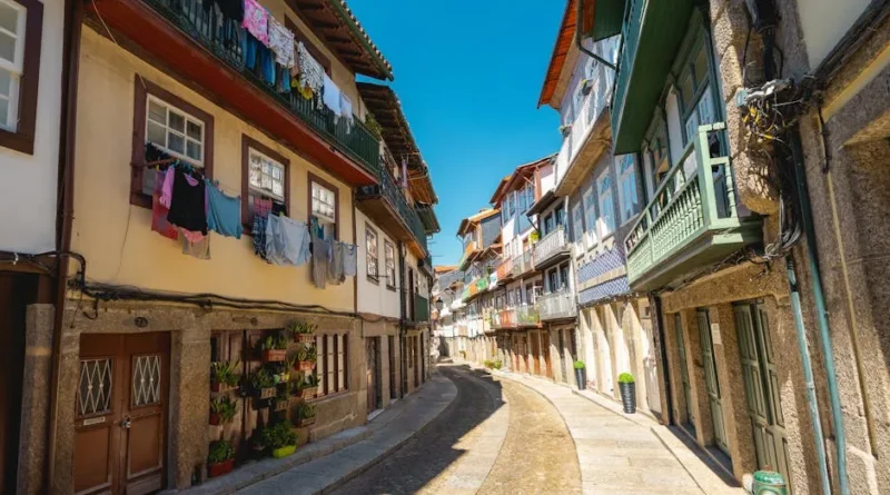 A narrow, colorful cobblestone street in a quiet, historic Baltic city with no tourists in sight
