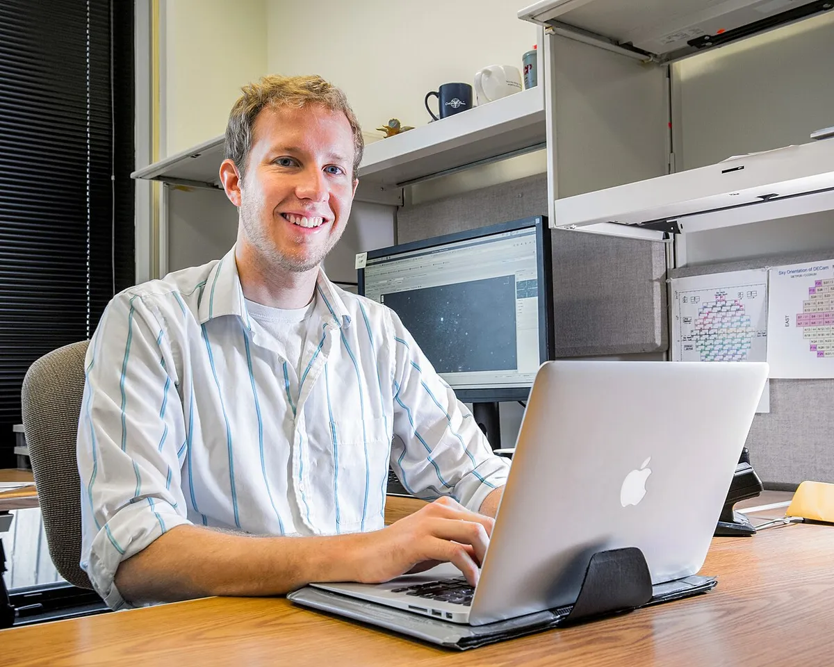 A diverse group of remote workers collaborating in a modern coworking space with city views