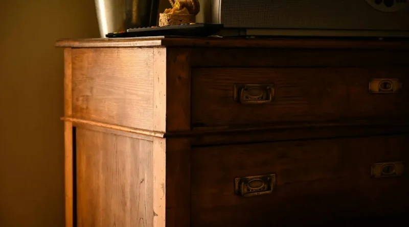 Solid wood vintage dresser inspected for joinery quality at an antique market
